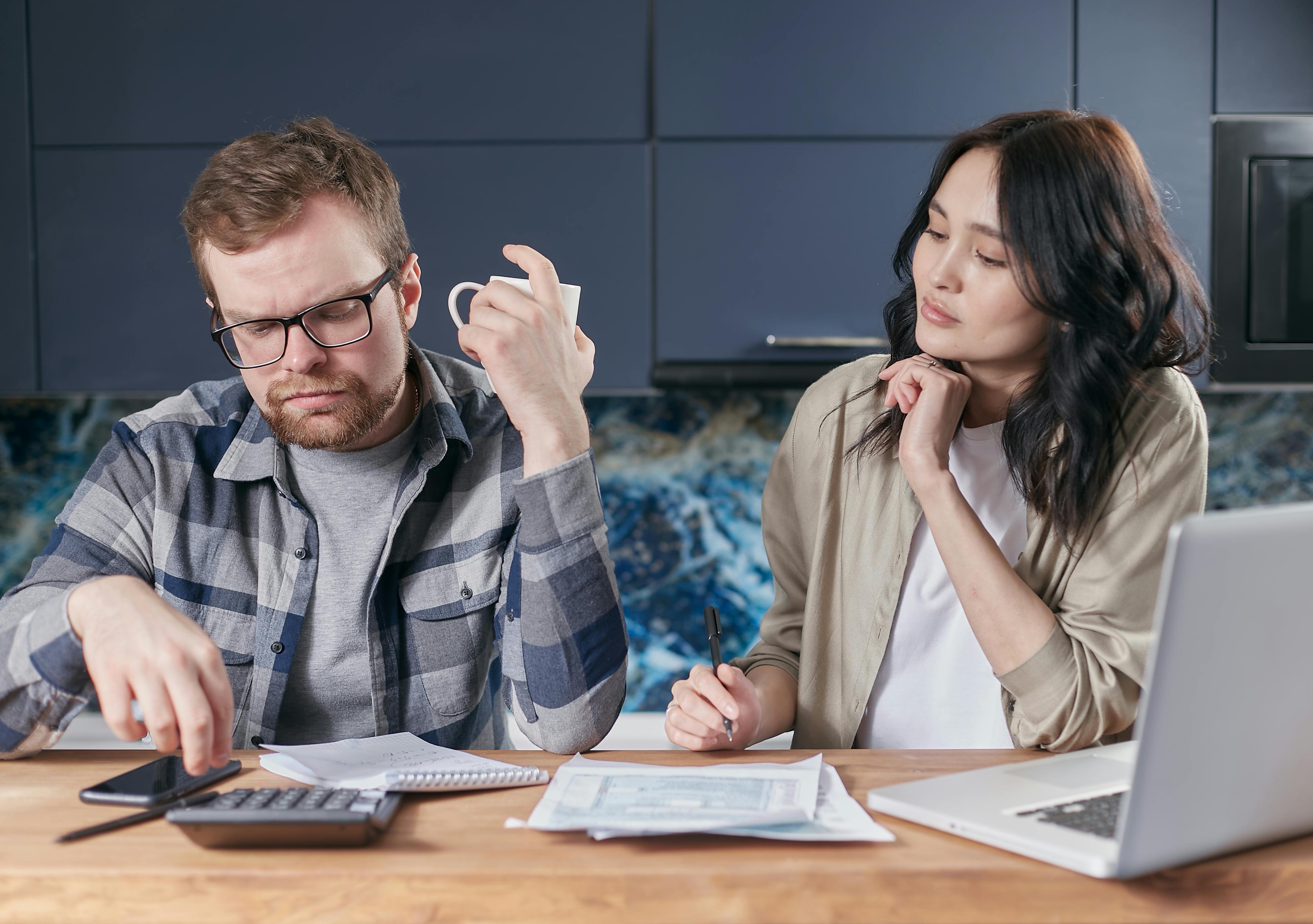 Man and woman looking at a calculator