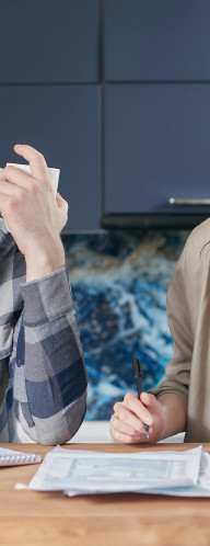 Man and woman looking at a calculator