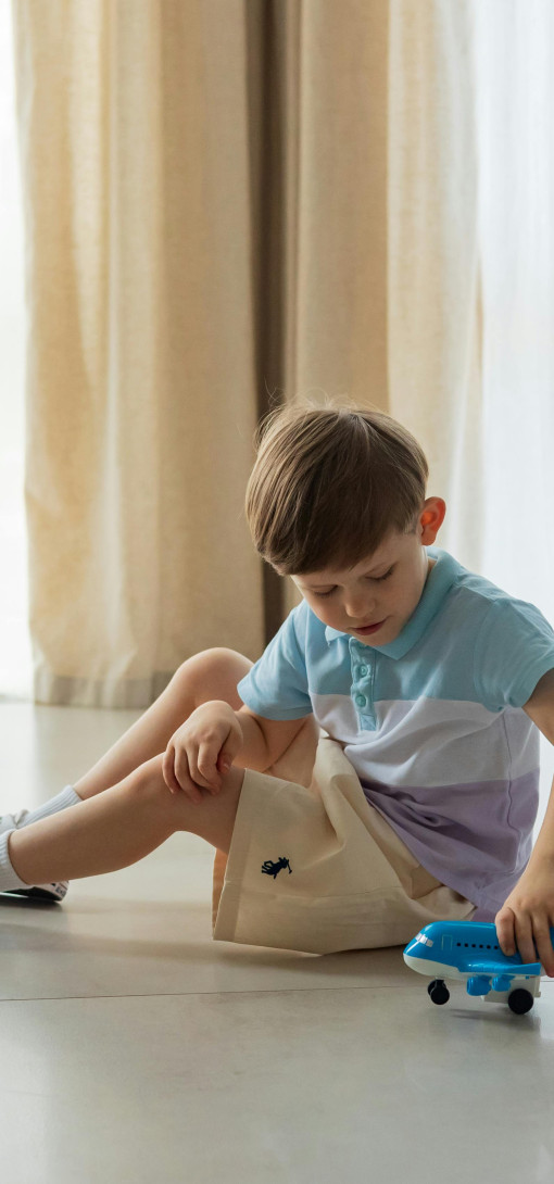 Child playing with a toy plane