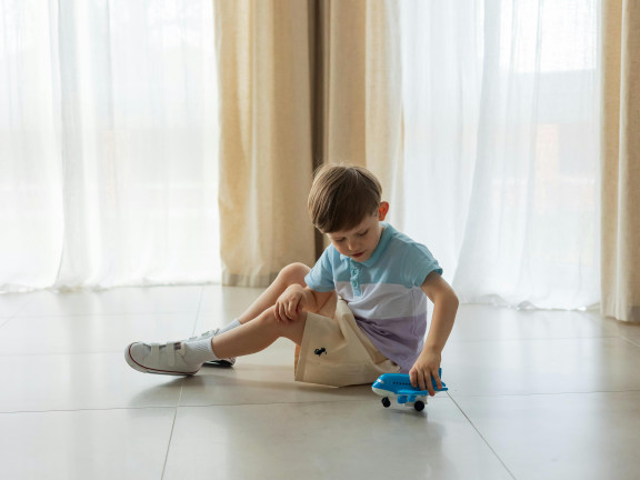 Child playing with a toy plane
