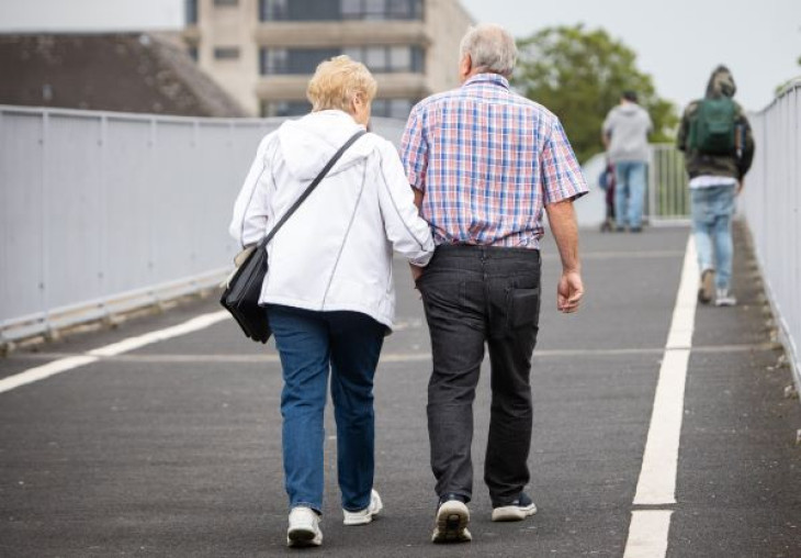 Older couple walking on bridge
