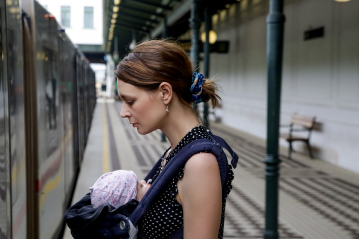 Woman getting on train with baby