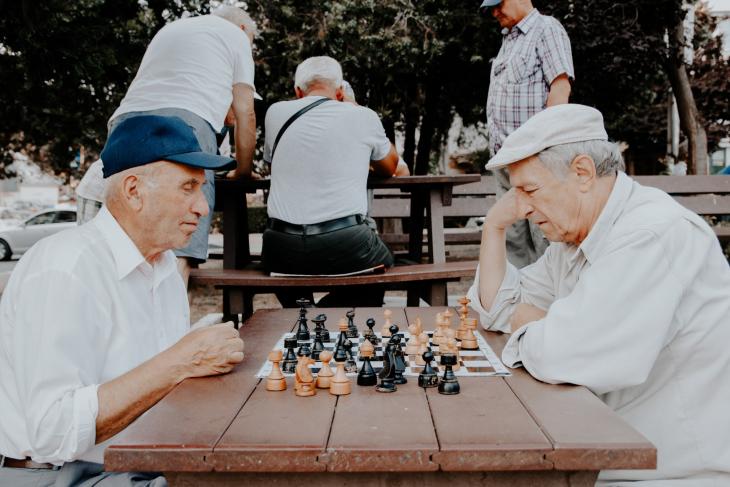 Two older men playing chess