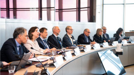 Experts around a table with microphones