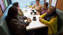 Grouo of older people discussing around a table