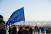 EU flag waved by people at demonstration in prague