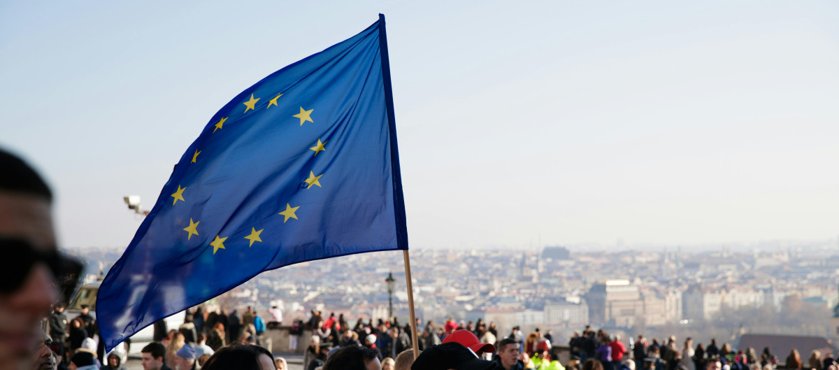 An EU Flag is waved at a demonstration